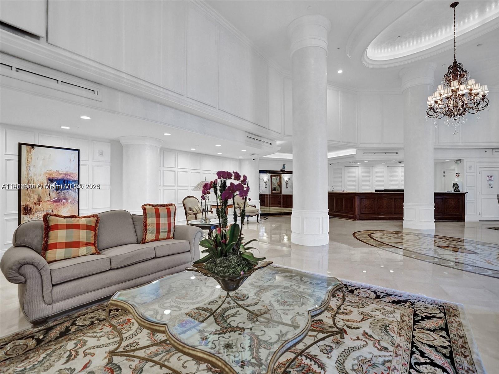 3530 Mystic Pointe Drive, Unit 1708 Aventura, FL 33180 - Photo 2 of 27 a living room with furniture and a flat screen tv