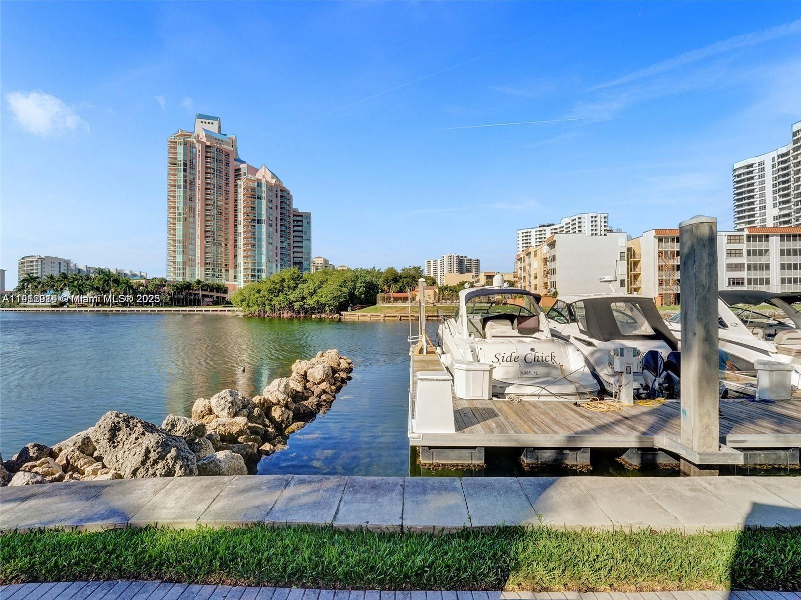 3530 Mystic Pointe Drive, Unit 1708 Aventura, FL 33180 - Photo 21 of 27 a view of a lake with tall buildings