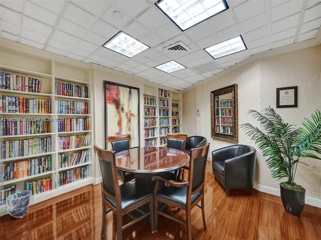 a dining room with furniture a book shelves