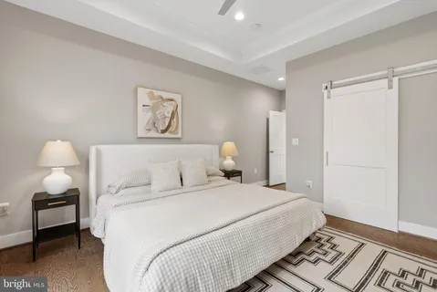 a bedroom with a bed and a large window