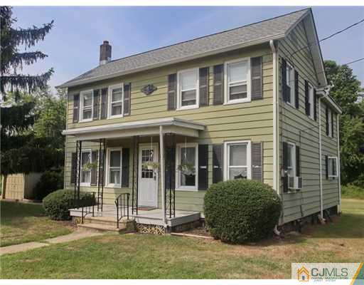 88 Halsey Reed Road Cranbury, NJ 08512 - Photo 1 of 18 a view of a white house with large windows and a yard