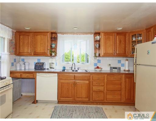 88 Halsey Reed Road Cranbury, NJ 08512 - Photo 11 of 18 a kitchen with stainless steel appliances granite countertop a sink stove and refrigerator