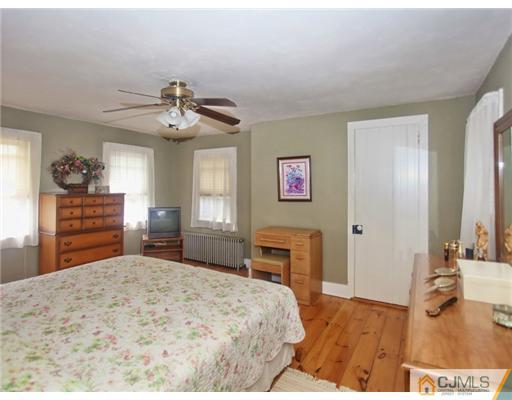 88 Halsey Reed Road Cranbury, NJ 08512 - Photo 13 of 18 a bedroom with a large bed and a chandelier