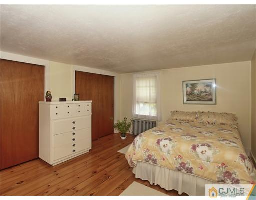88 Halsey Reed Road Cranbury, NJ 08512 - Photo 14 of 18 a bedroom with a bed and a dresser