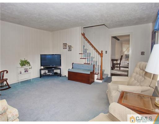 88 Halsey Reed Road Cranbury, NJ 08512 - Photo 5 of 18 a living room with furniture and a flat screen tv