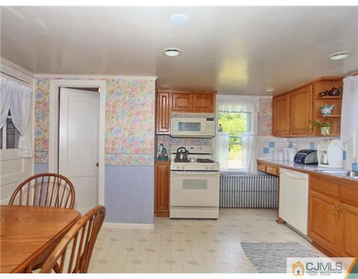 88 Halsey Reed Road Cranbury, NJ 08512 - Photo 9 of 18 a kitchen with stainless steel appliances granite countertop a stove a sink and a refrigerator