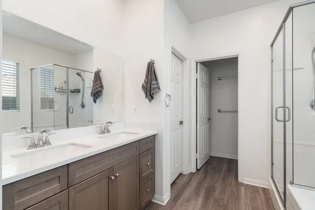 a bathroom with a double vanity sink and mirror