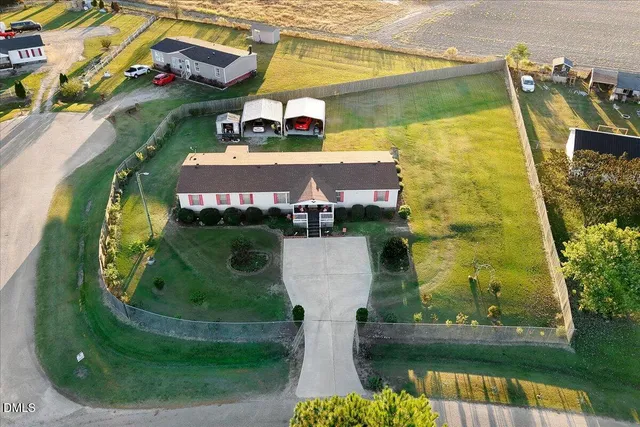 an aerial view of a house with a garden and swimming pool