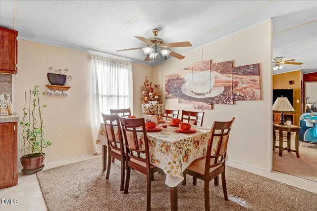 a view of a dining room with furniture and chandelier