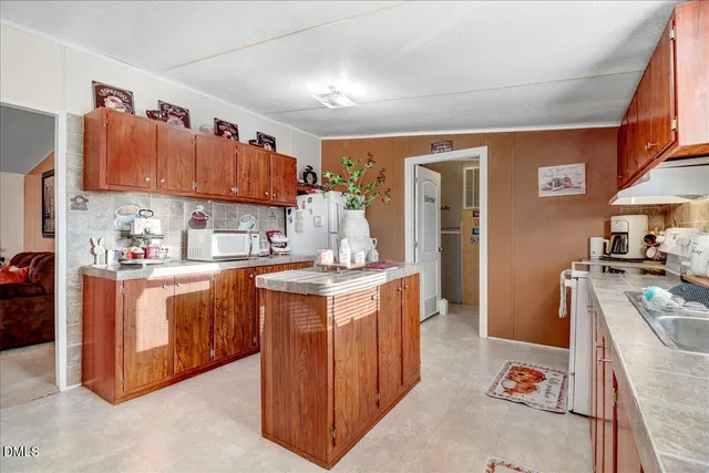 a kitchen with stainless steel appliances granite countertop wooden cabinets a sink and dishwasher