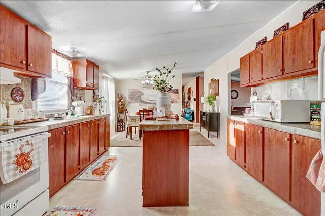 a kitchen with stainless steel appliances a sink stove and cabinets
