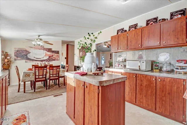 a large kitchen with stainless steel appliances lots of counter space and a sink