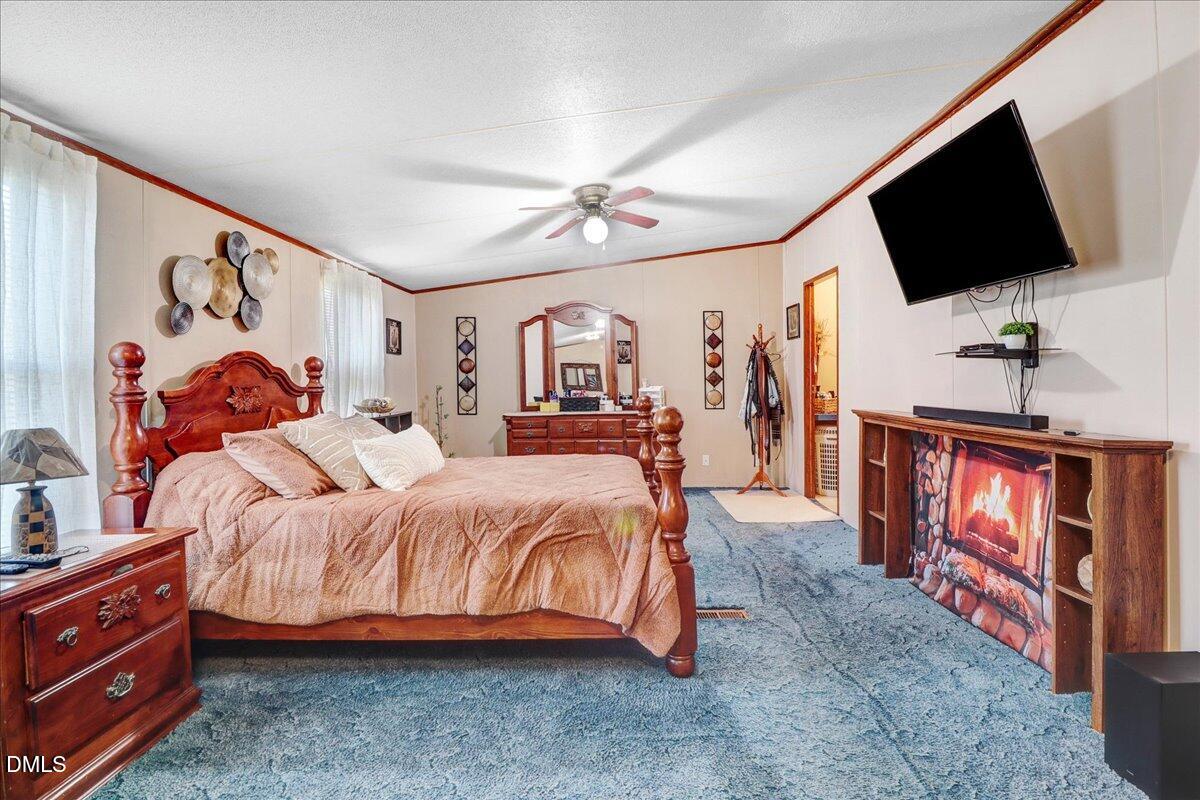 4305 Chinook Road Wilson, NC 27893 - Photo 26 of 37 a spacious bedroom with a bed and a flat screen tv