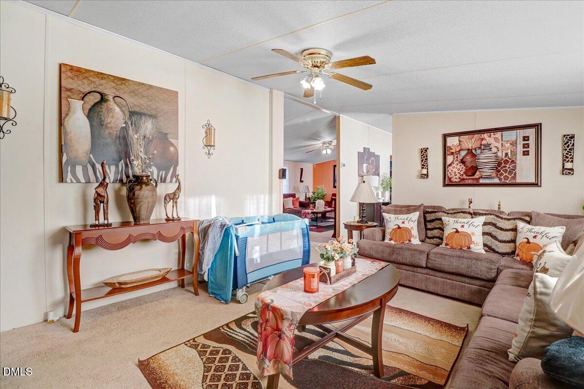 4305 Chinook Road Wilson, NC 27893 - Photo 31 of 37 a living room with furniture and a painting on the wall