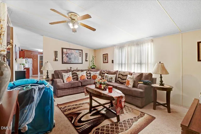 a living room with furniture and a painting on the wall