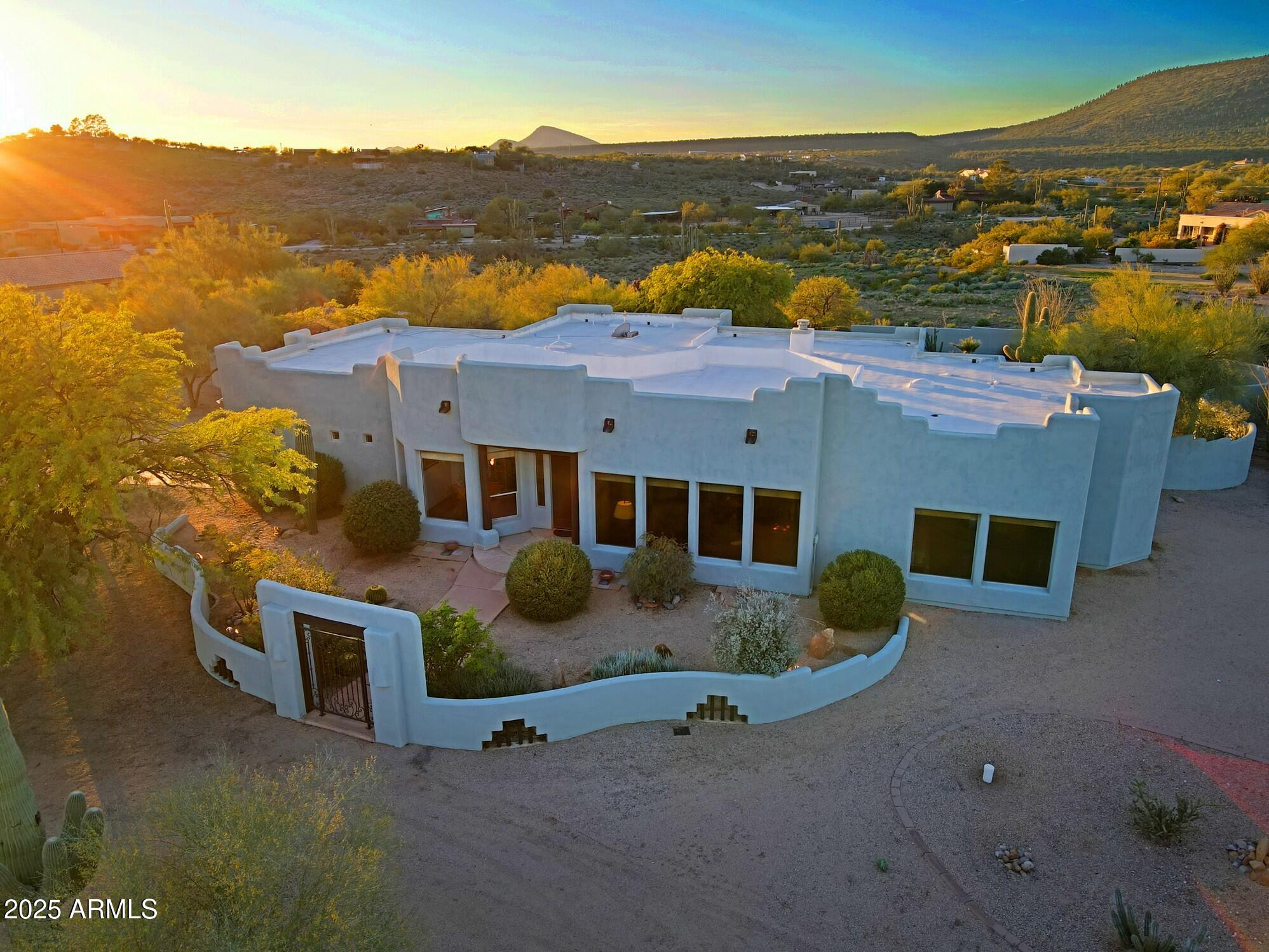 an aerial view of residential houses with outdoor space and ocean view
