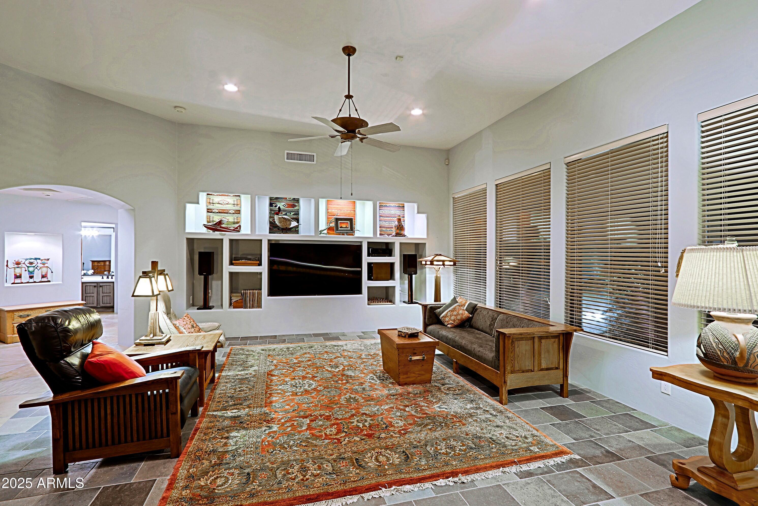 41840 North Spur Cross Road Cave Creek, AZ 85331 - Photo 15 of 67 a living room with furniture gym equipment and a rug
