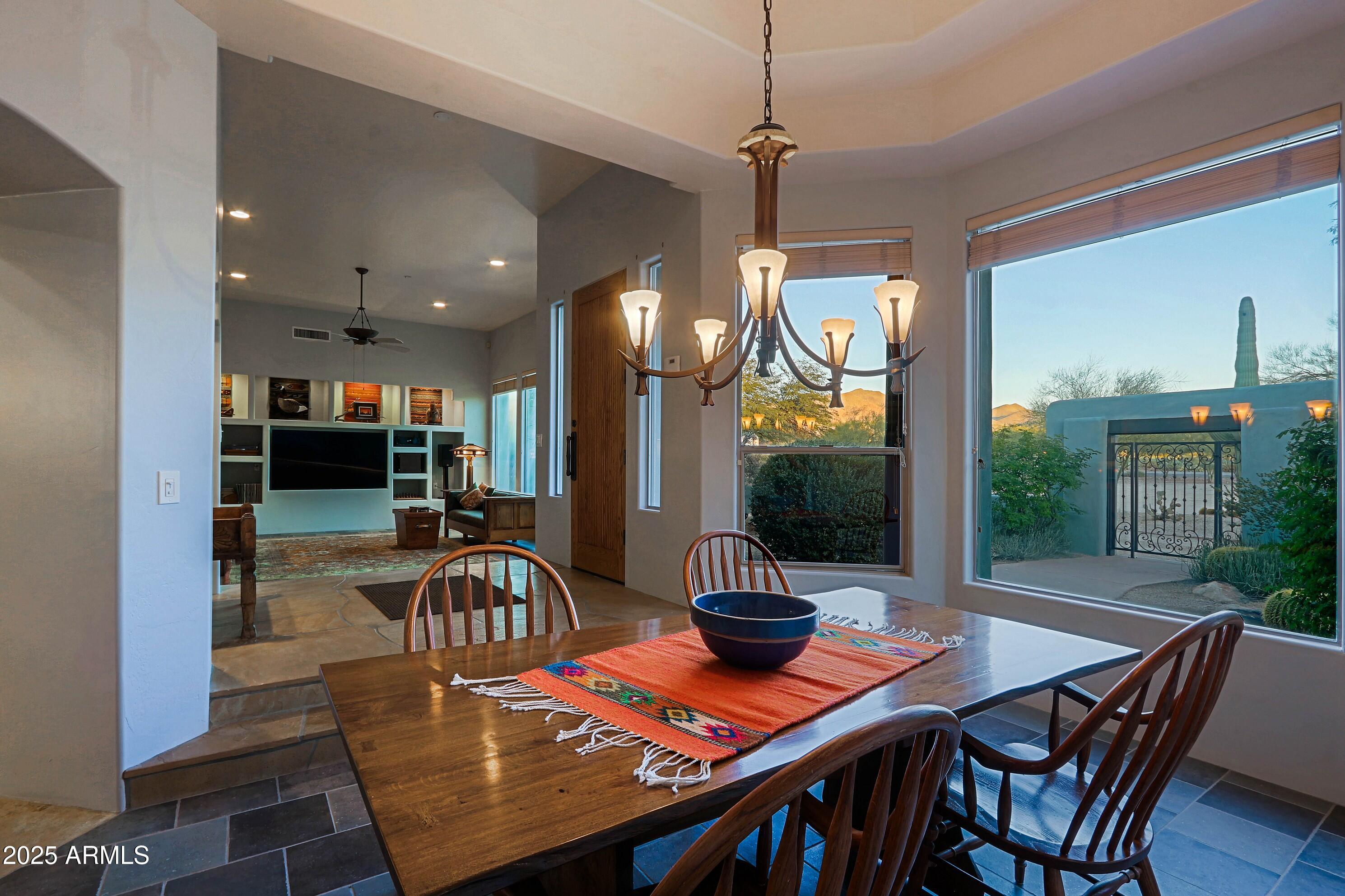 41840 North Spur Cross Road Cave Creek, AZ 85331 - Photo 16 of 67 a view of a dining room and livingroom with furniture wooden floor a chandelier