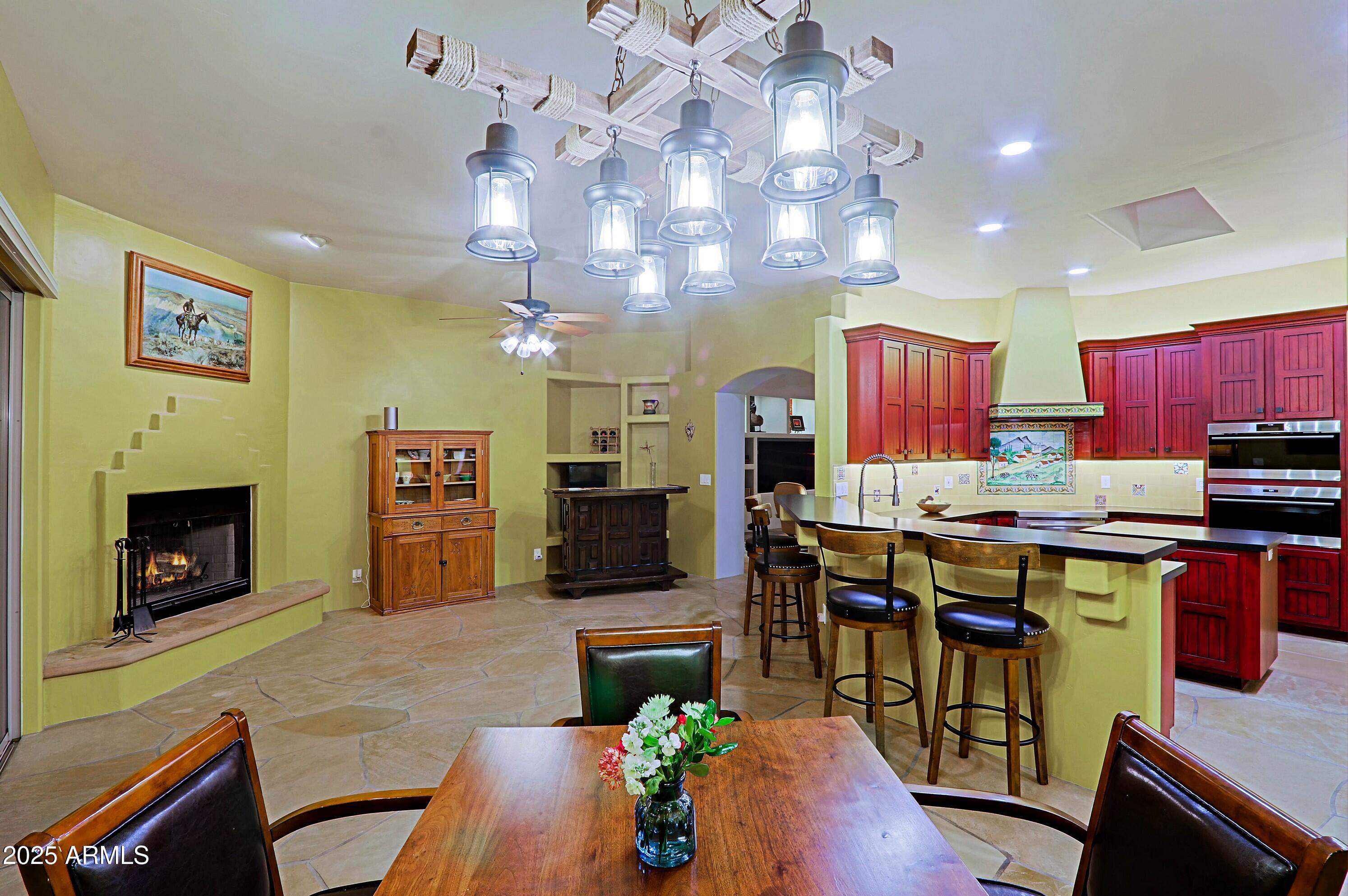 41840 North Spur Cross Road Cave Creek, AZ 85331 - Photo 23 of 67 a living room with furniture a flat screen tv and a fireplace