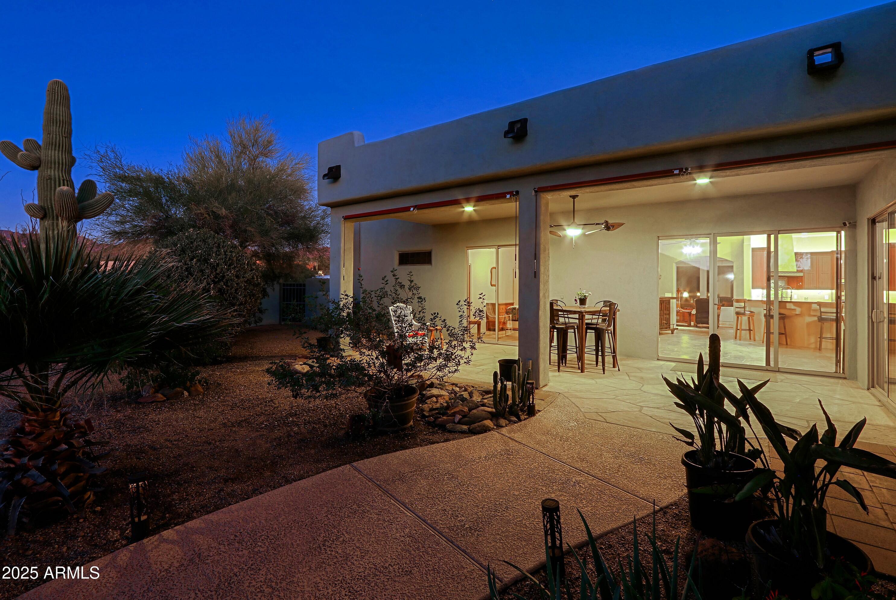 41840 North Spur Cross Road Cave Creek, AZ 85331 - Photo 29 of 67 a view of a patio with table and chairs potted plants with wooden fence