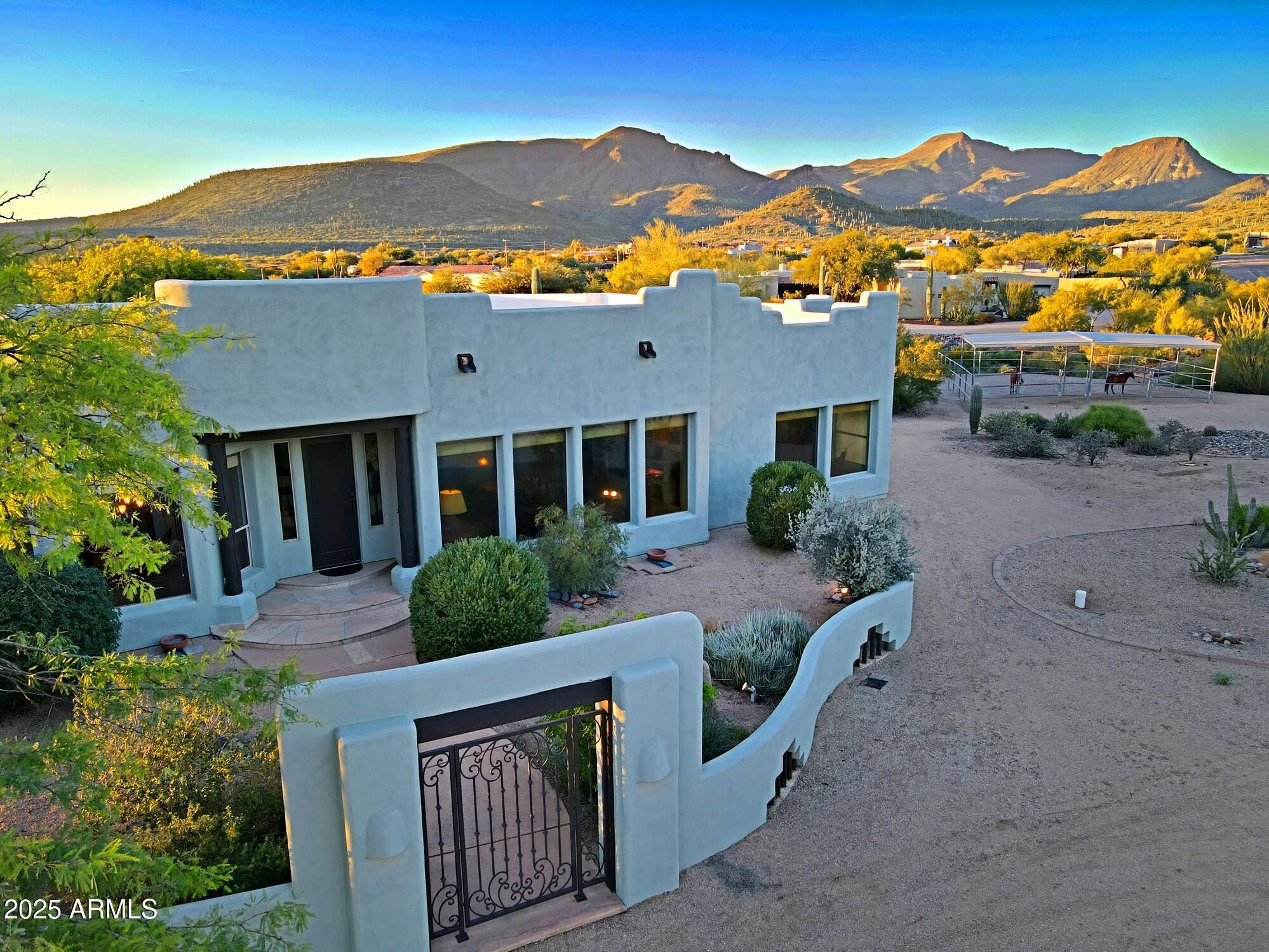41840 North Spur Cross Road Cave Creek, AZ 85331 - Photo 3 of 67 a front view of house with yard and mountain view in back