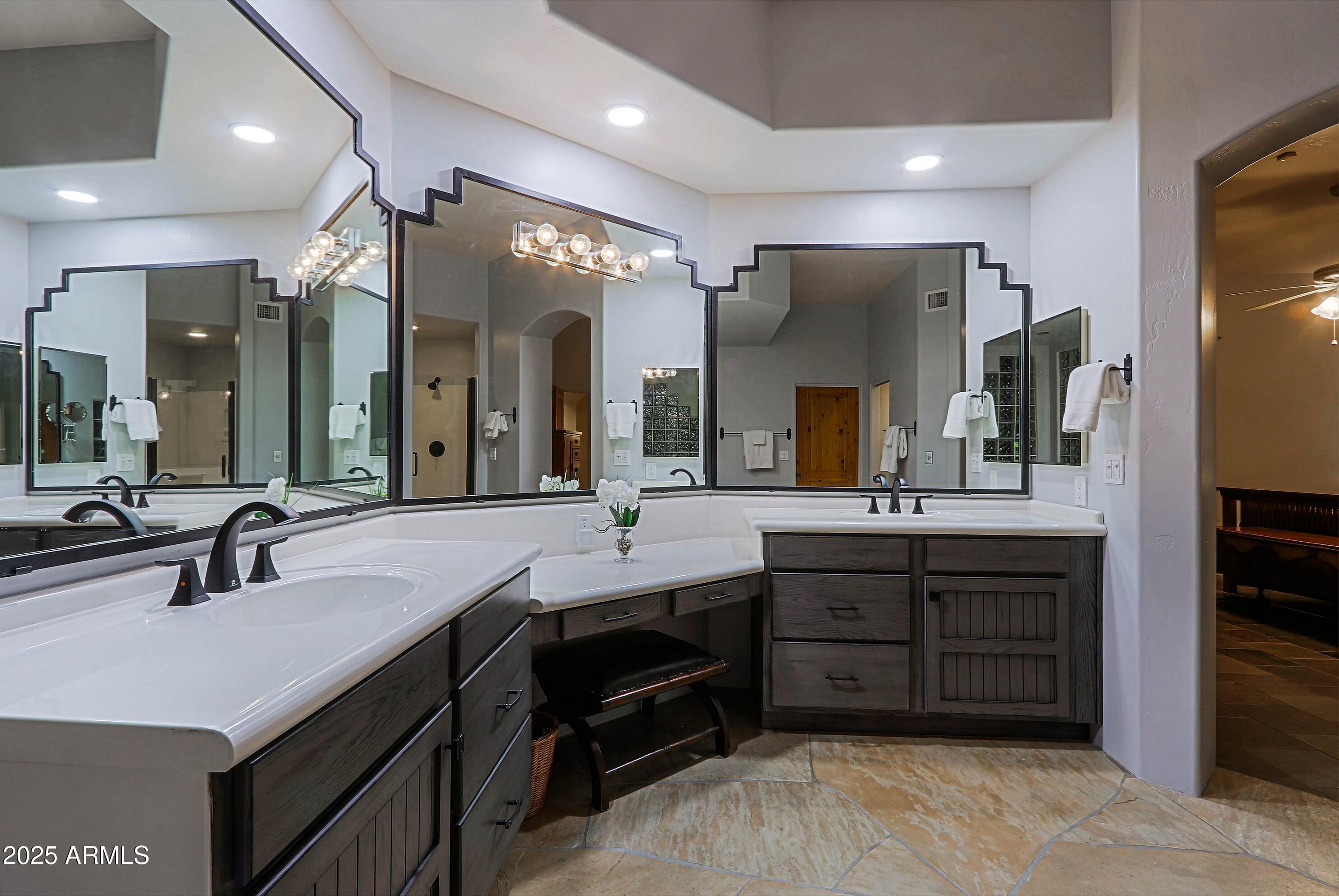 41840 North Spur Cross Road Cave Creek, AZ 85331 - Photo 49 of 67 a spacious bathroom with a double vanity sink and a large mirror