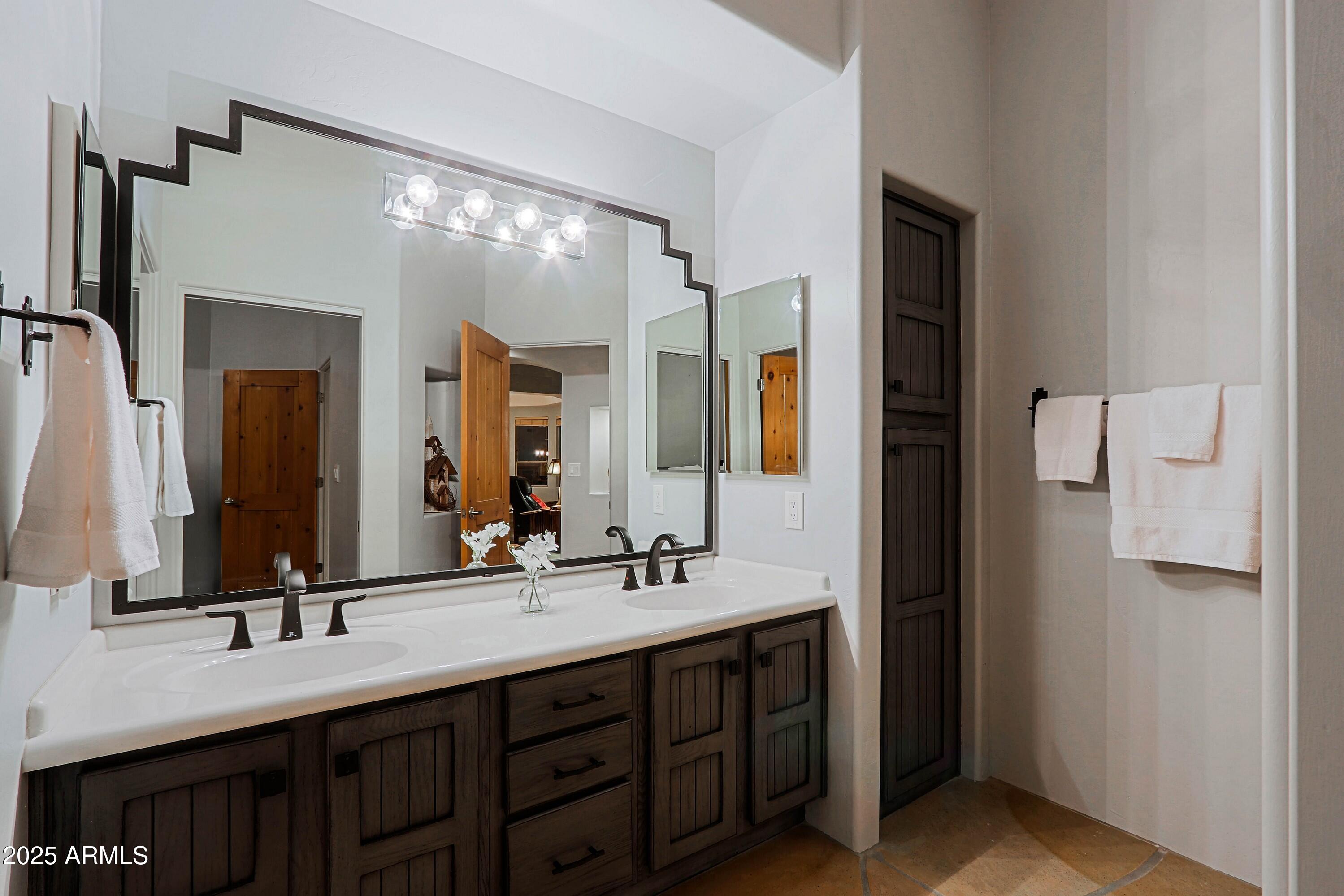 41840 North Spur Cross Road Cave Creek, AZ 85331 - Photo 58 of 67 a bathroom with a double vanity sink and a mirror