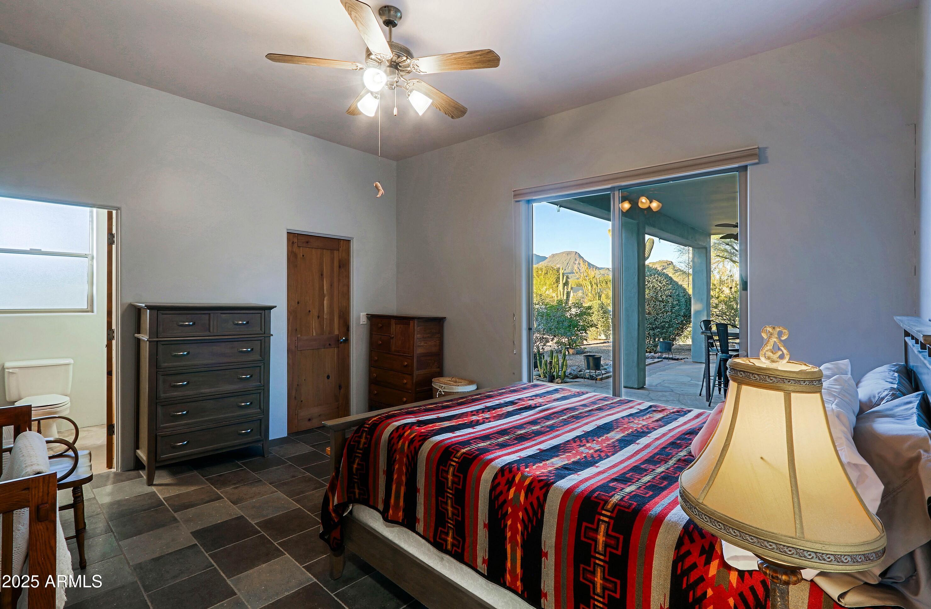 41840 North Spur Cross Road Cave Creek, AZ 85331 - Photo 60 of 67 a bedroom with a bed and a mirror