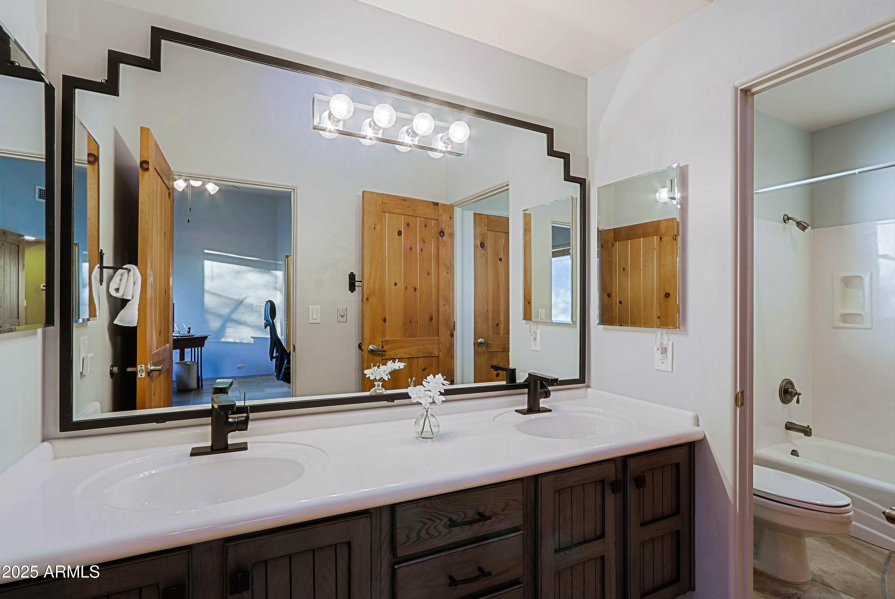 41840 North Spur Cross Road Cave Creek, AZ 85331 - Photo 62 of 67 a bathroom with a double vanity sink and a mirror