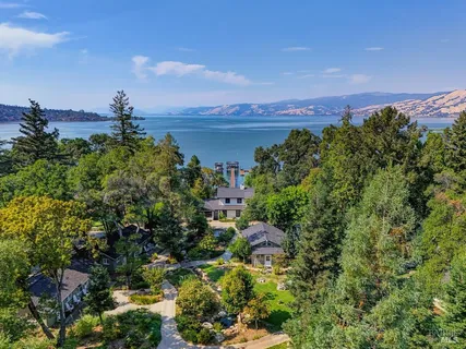 a dining room with furniture a chandelier and wooden floor