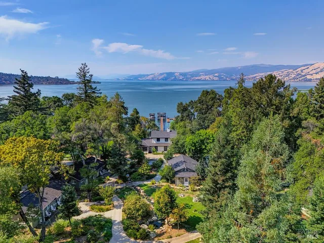 a dining room with furniture a chandelier and wooden floor