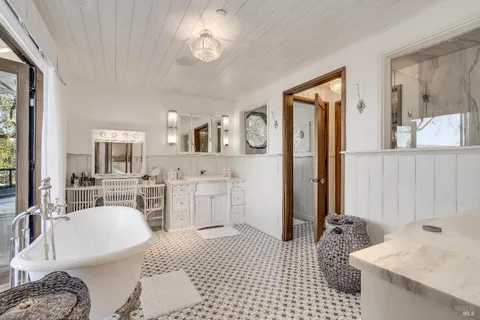 a view of a patio with table and chairs potted plants and large tree