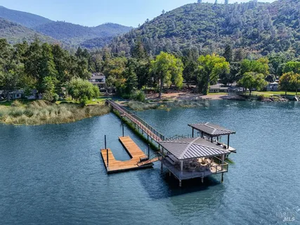 a kitchen with a dining table chairs and kitchen view
