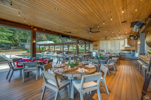 an aerial view of residential houses with outdoor space and trees
