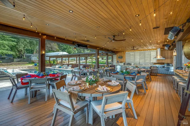 an aerial view of residential houses with outdoor space and trees