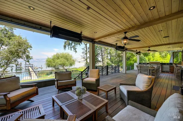a living room with furniture a flat screen tv and a table