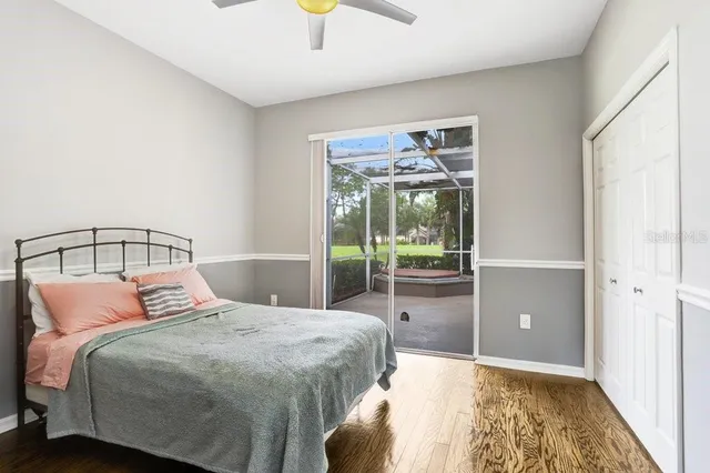 a bedroom with a large bed and a chandelier