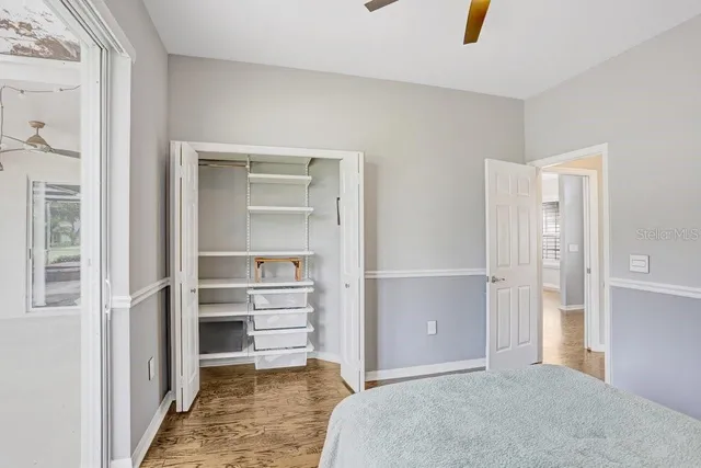 a view of a bedroom with closet and cabinet