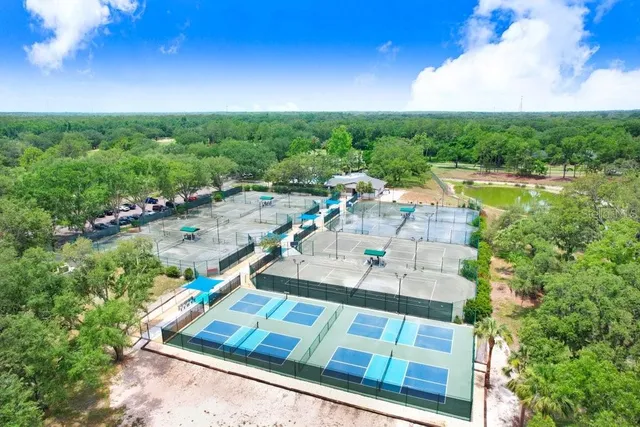 a view of a house with a yard and lake view