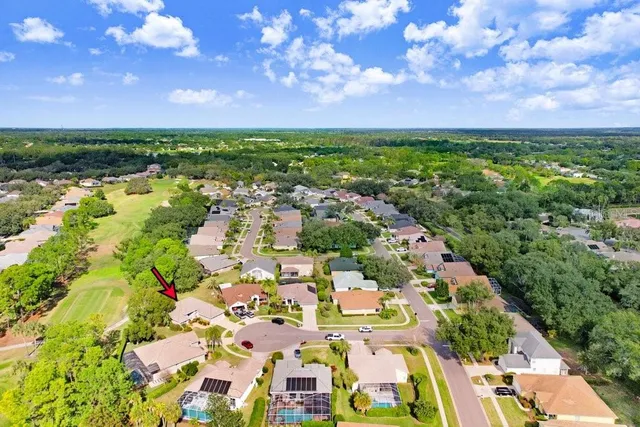 an aerial view of a house with garden space and outdoor seating