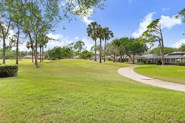 a view of a house with a yard and sitting area
