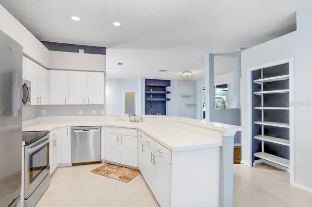 a kitchen with a sink a oven a counter space and cabinets