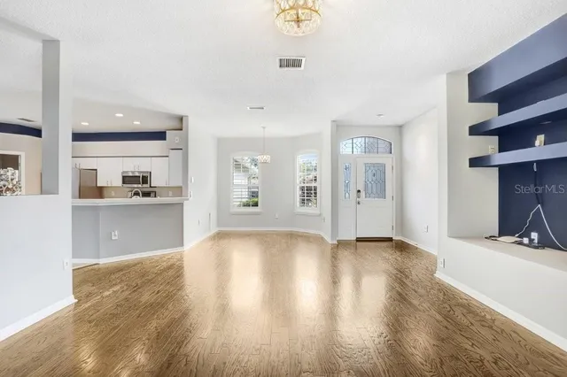a view of a kitchen with a sink and a refrigerator