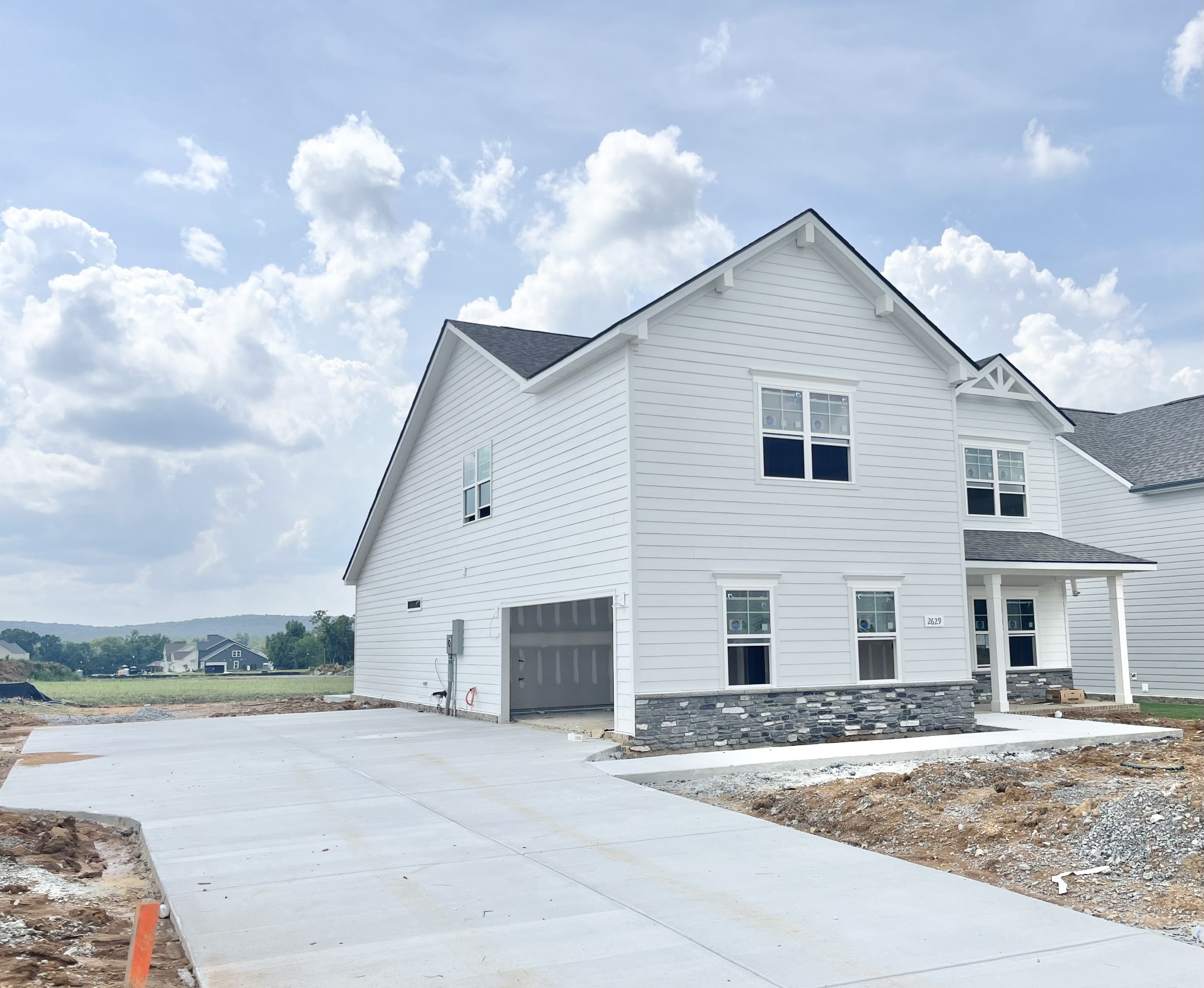 2629 Unitas Drive Murfreesboro, TN 37129 - Photo 2 of 20 a view of a white house with a yard and garage