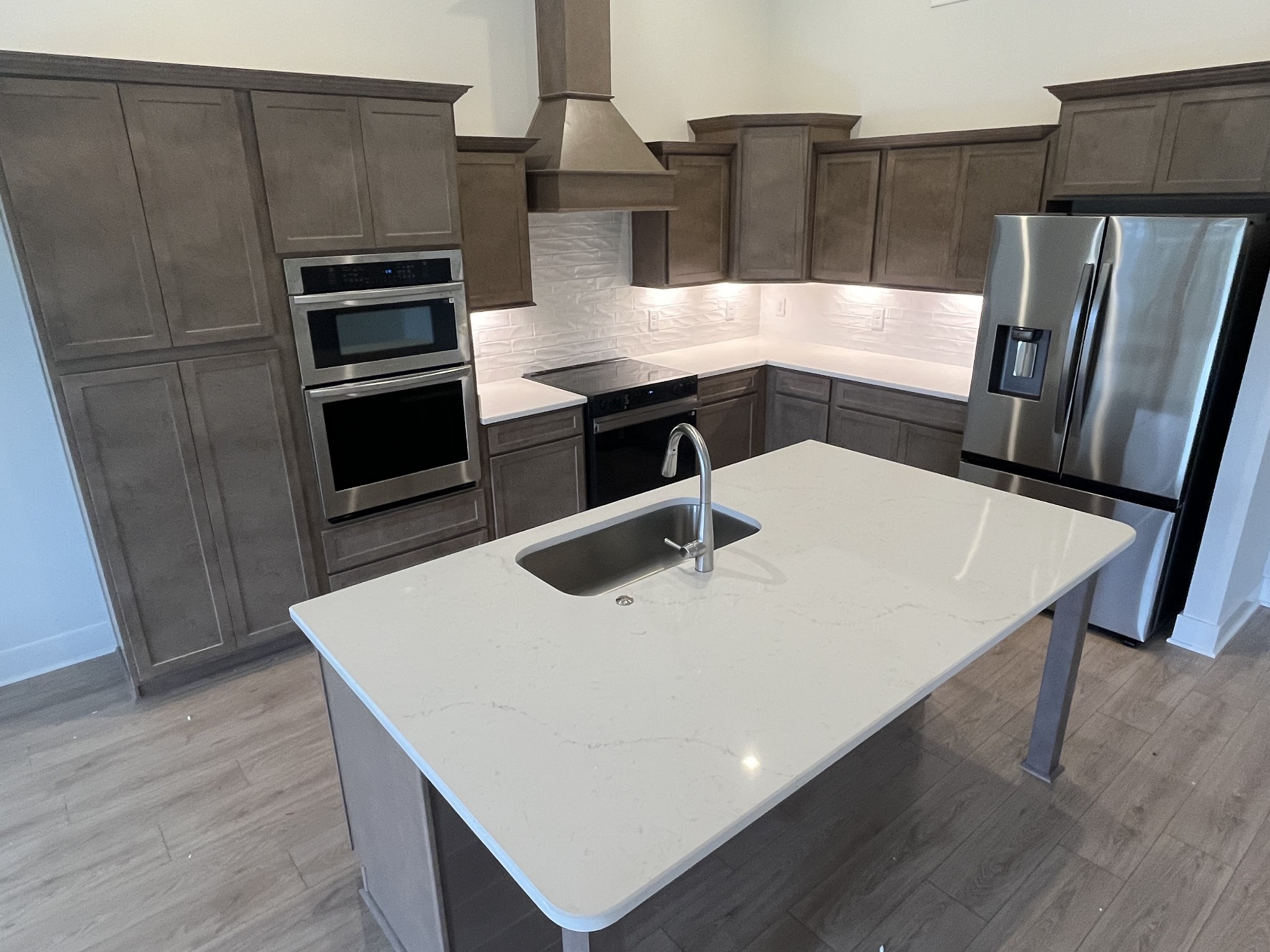 2629 Unitas Drive Murfreesboro, TN 37129 - Photo 7 of 20 a kitchen with stainless steel appliances a kitchen island wooden floors white cabinets appliances and a sink