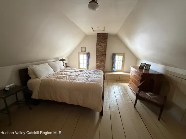 a bedroom with bed and window