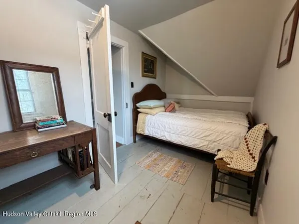 a bedroom with a bed a desk and chair