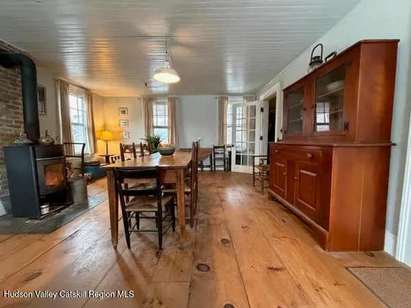 a living room with furniture a dining table and chairs with wooden floor