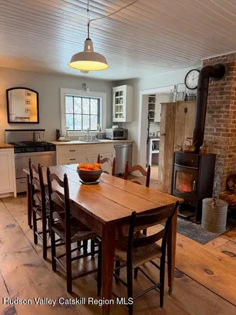a dining room with furniture a chandelier and wooden floor