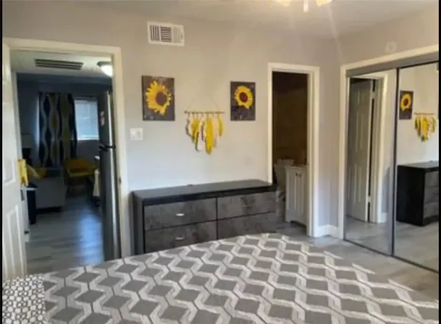 a bedroom with a bed and a view of bathroom